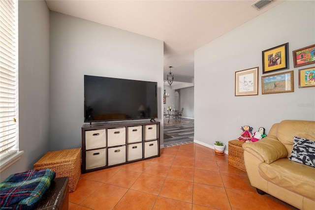 living room with baseboards, visible vents, and light tile patterned flooring