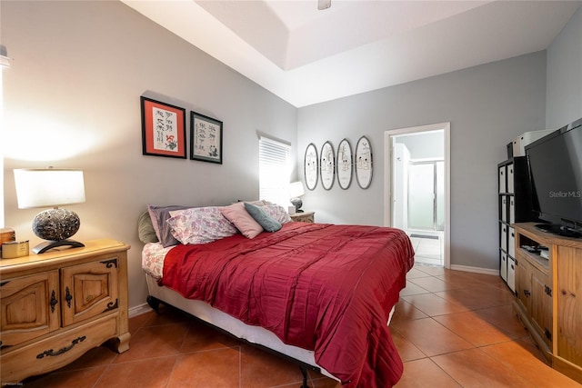 bedroom with light tile patterned flooring, connected bathroom, and baseboards