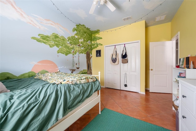 bedroom with ceiling fan, a closet, tile patterned flooring, and visible vents