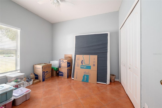 interior space with ceiling fan and light tile patterned floors