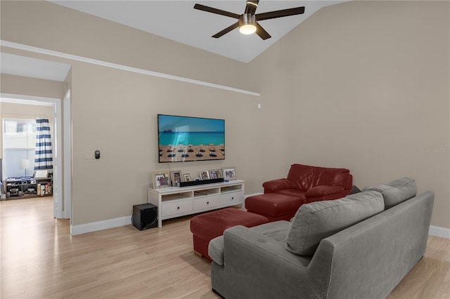 living room featuring lofted ceiling, light hardwood / wood-style flooring, and ceiling fan