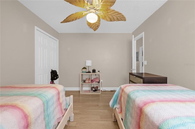 bedroom featuring a closet, ceiling fan, and light wood-type flooring