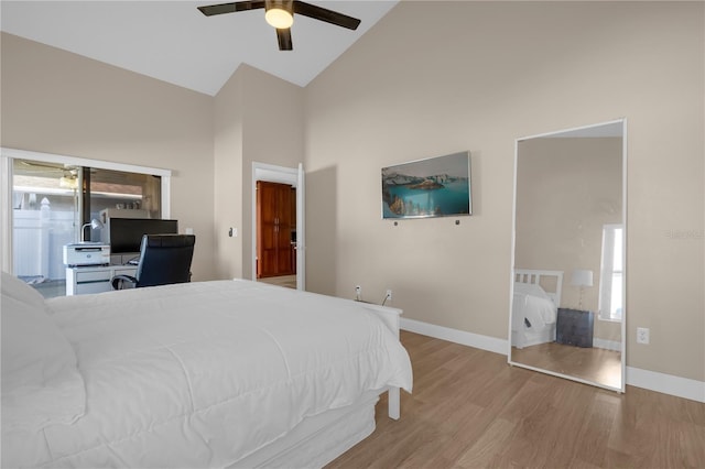 bedroom featuring high vaulted ceiling, light hardwood / wood-style floors, and ceiling fan