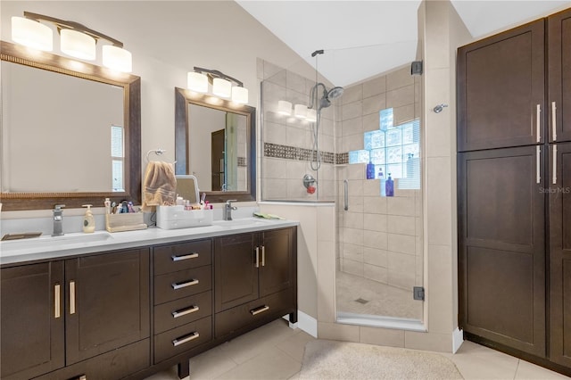 bathroom featuring vanity, vaulted ceiling, tile patterned floors, and walk in shower