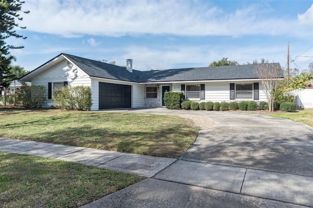 ranch-style house with a garage and a front lawn