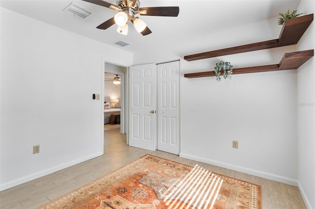 spare room with light hardwood / wood-style floors and ceiling fan