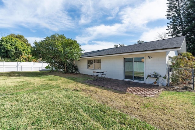 rear view of property with a yard and a patio area