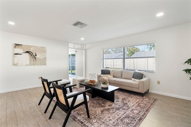 living room with light hardwood / wood-style flooring and a wealth of natural light