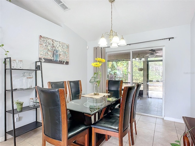 dining room with lofted ceiling, light tile patterned floors, and an inviting chandelier