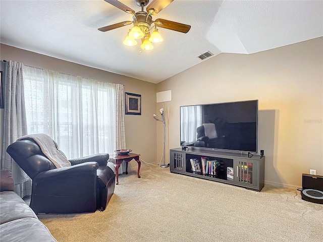 living room with carpet flooring, vaulted ceiling, and a textured ceiling