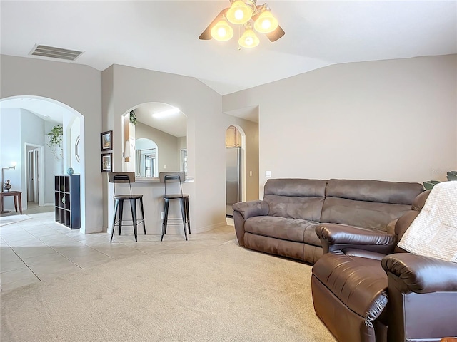 carpeted living room featuring ceiling fan and vaulted ceiling