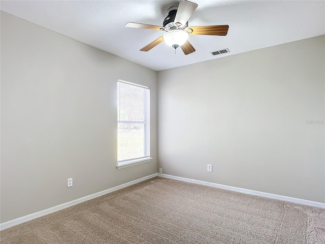 carpeted empty room featuring ceiling fan