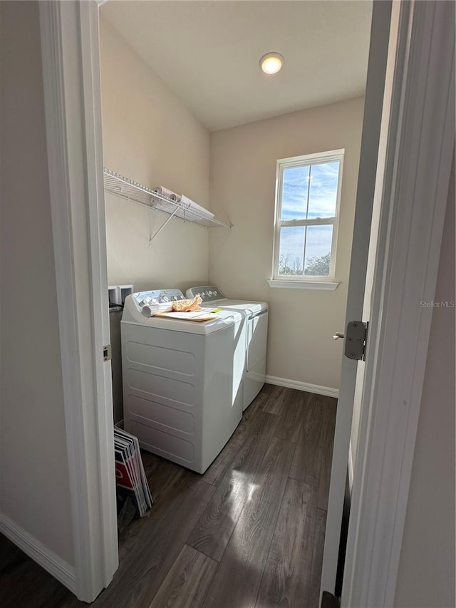 laundry room featuring dark wood-type flooring and washer and clothes dryer