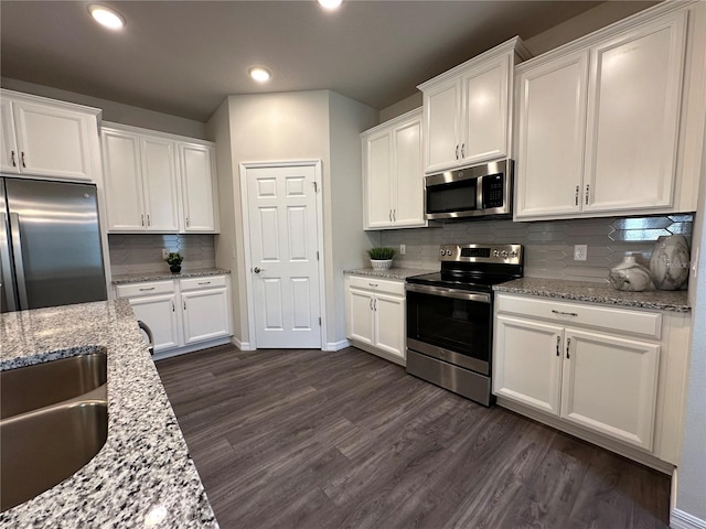 kitchen featuring tasteful backsplash, stainless steel appliances, and white cabinets