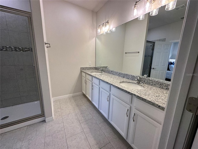 bathroom featuring vanity, an enclosed shower, and tile patterned flooring