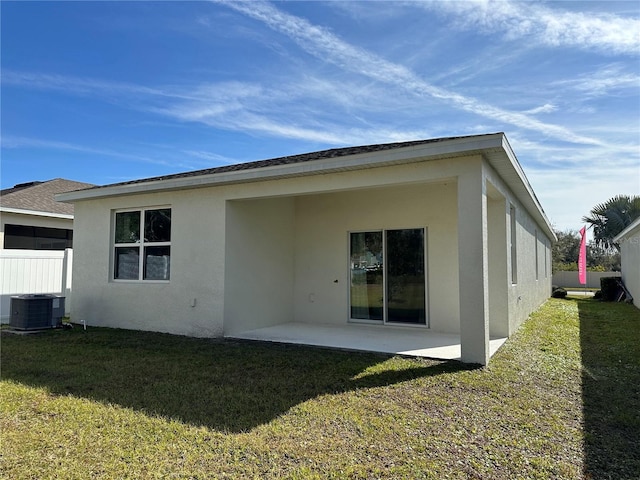 back of house with a yard, a patio area, and central air condition unit