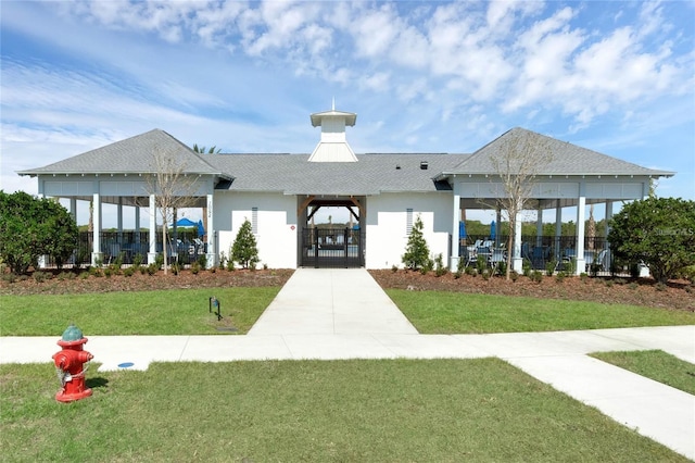 view of home's community featuring a gate and a yard