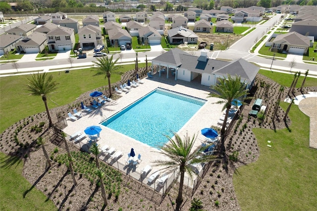 pool featuring a patio area, fence, and a residential view