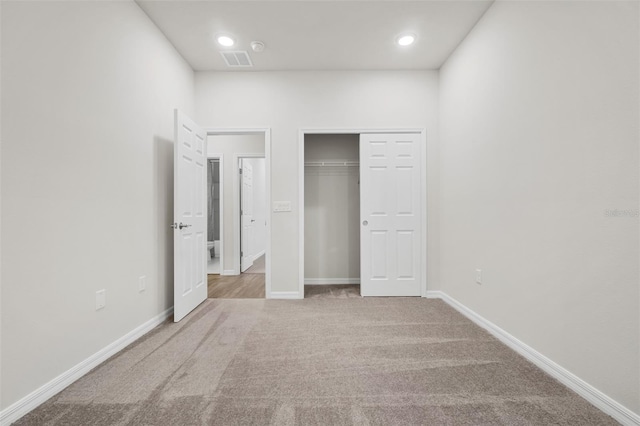 unfurnished bedroom featuring visible vents, baseboards, carpet, recessed lighting, and a closet