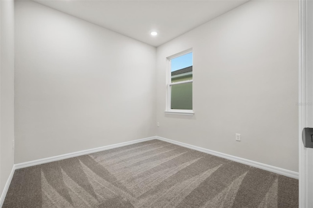 empty room with recessed lighting, baseboards, and carpet