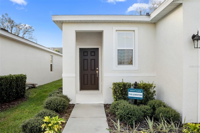 entrance to property with stucco siding