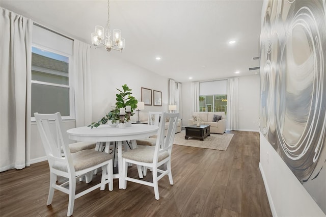 dining room featuring recessed lighting, baseboards, an inviting chandelier, and wood finished floors