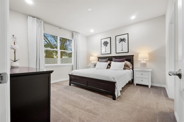 bedroom with recessed lighting, light colored carpet, and baseboards