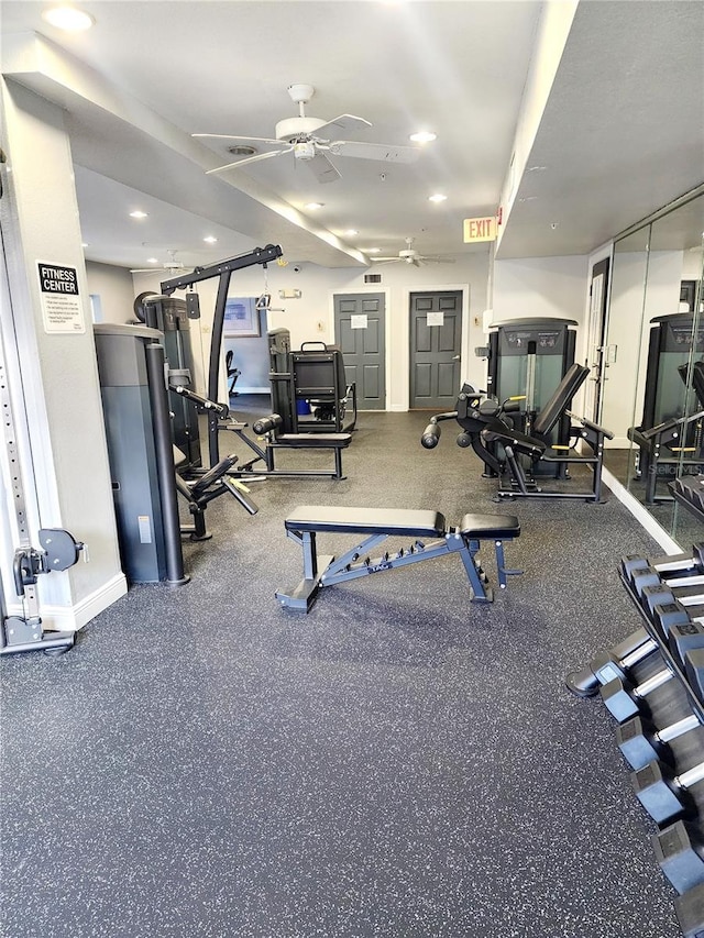 workout area featuring ceiling fan and baseboards