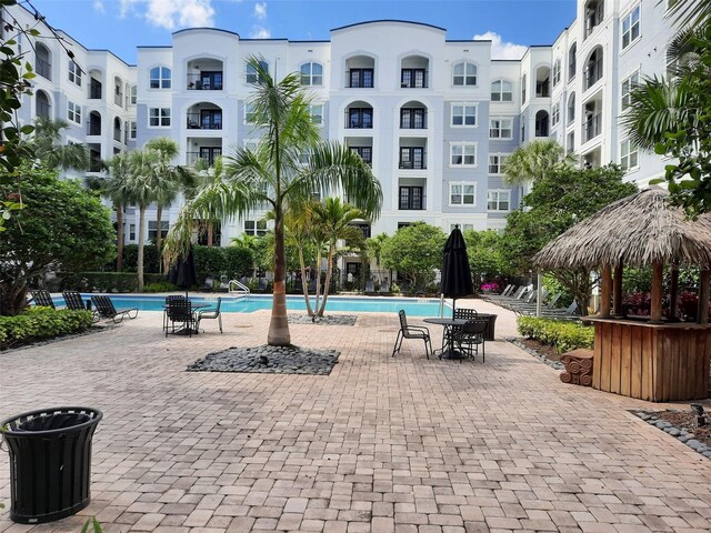 view of property's community featuring a pool and a patio area