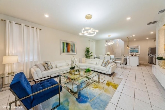 living room featuring light tile patterned floors and a notable chandelier