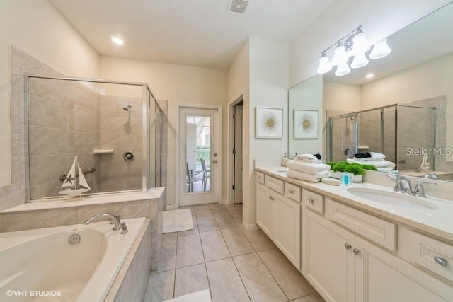 bathroom with vanity, tile patterned floors, and shower with separate bathtub