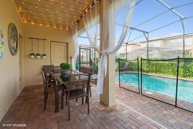 view of swimming pool featuring a lanai and a patio area