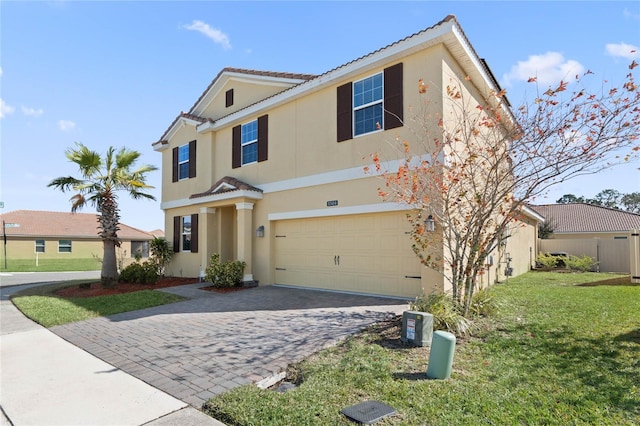 view of front of property featuring a garage and a front lawn