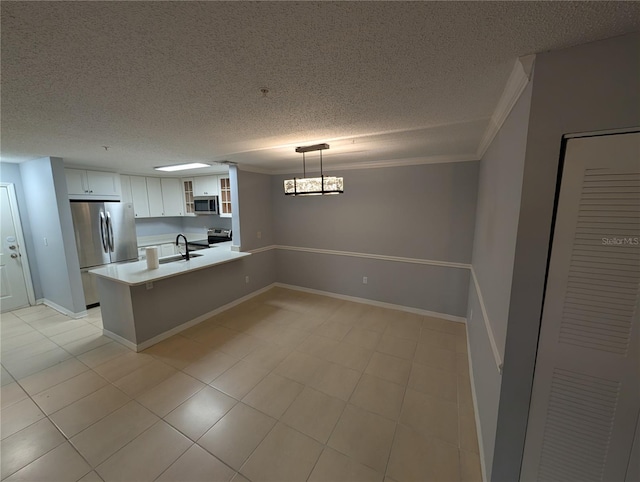 kitchen with sink, white cabinetry, hanging light fixtures, appliances with stainless steel finishes, and kitchen peninsula