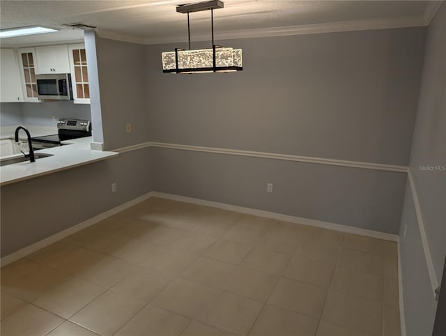 unfurnished dining area featuring crown molding, sink, and a textured ceiling