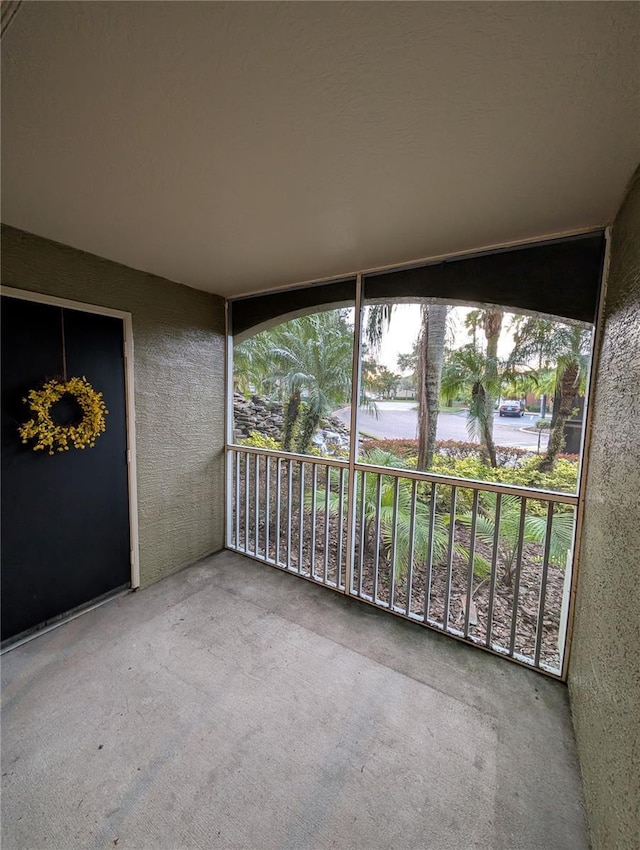 unfurnished sunroom with a water view