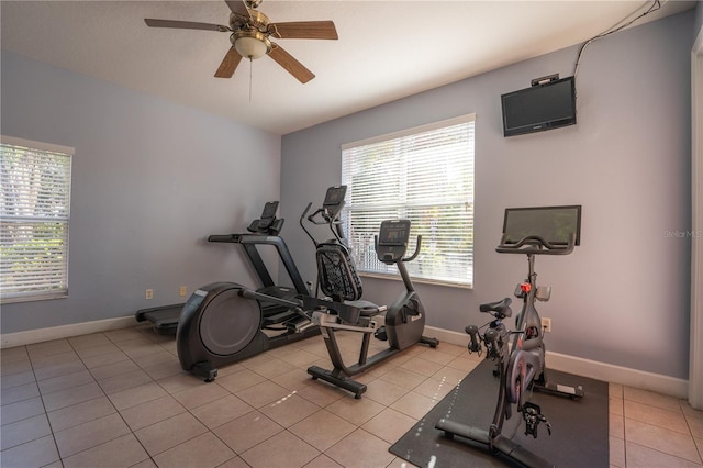 workout room with ceiling fan, a healthy amount of sunlight, and light tile patterned floors