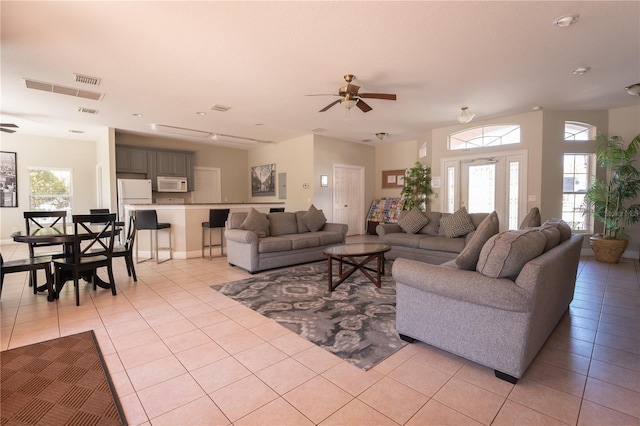 living room featuring ceiling fan and light tile patterned floors