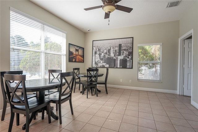 tiled dining area featuring ceiling fan