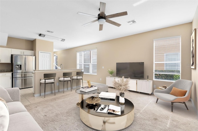 tiled living room featuring ceiling fan