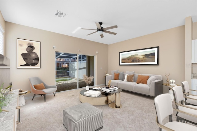 carpeted living room featuring ceiling fan and a healthy amount of sunlight