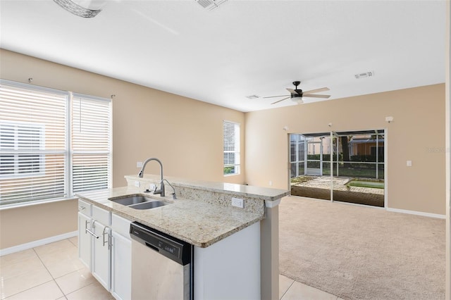 kitchen featuring dishwasher, sink, white cabinets, light colored carpet, and a center island with sink