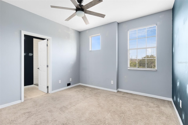 empty room with ceiling fan and light colored carpet