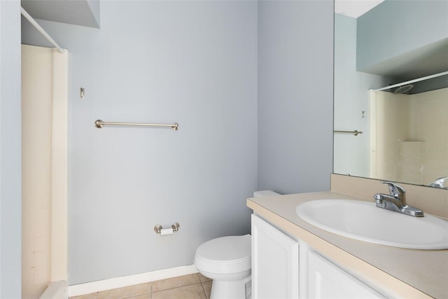 bathroom featuring tile patterned flooring, vanity, a shower, and toilet