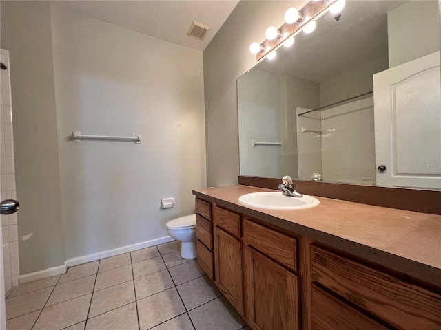 bathroom featuring walk in shower, vanity, toilet, and tile patterned flooring