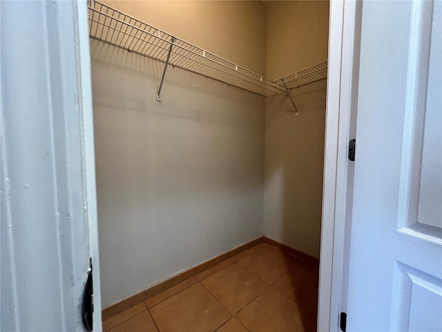 spacious closet featuring tile patterned flooring