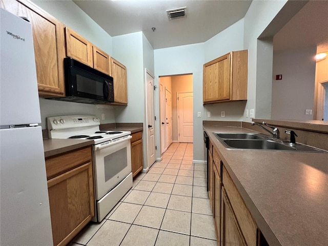 kitchen with sink, light tile patterned floors, and white appliances