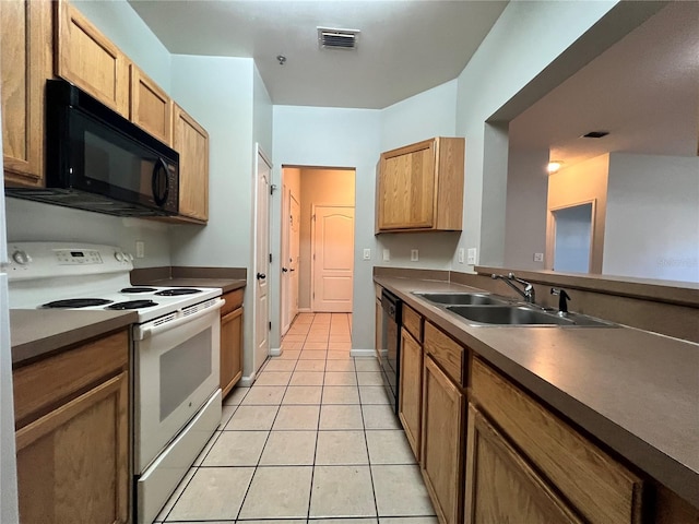 kitchen with sink, light tile patterned floors, and black appliances