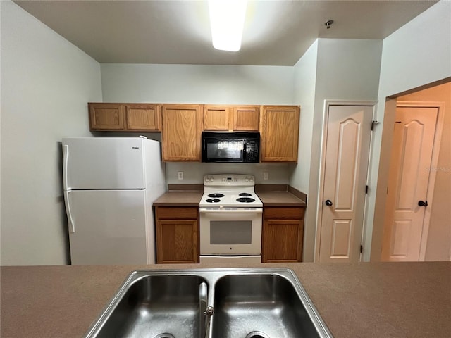 kitchen with sink and white appliances