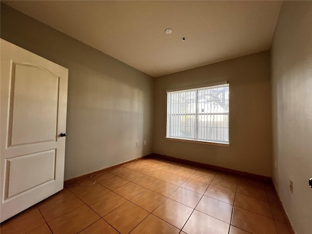 unfurnished room with light tile patterned floors